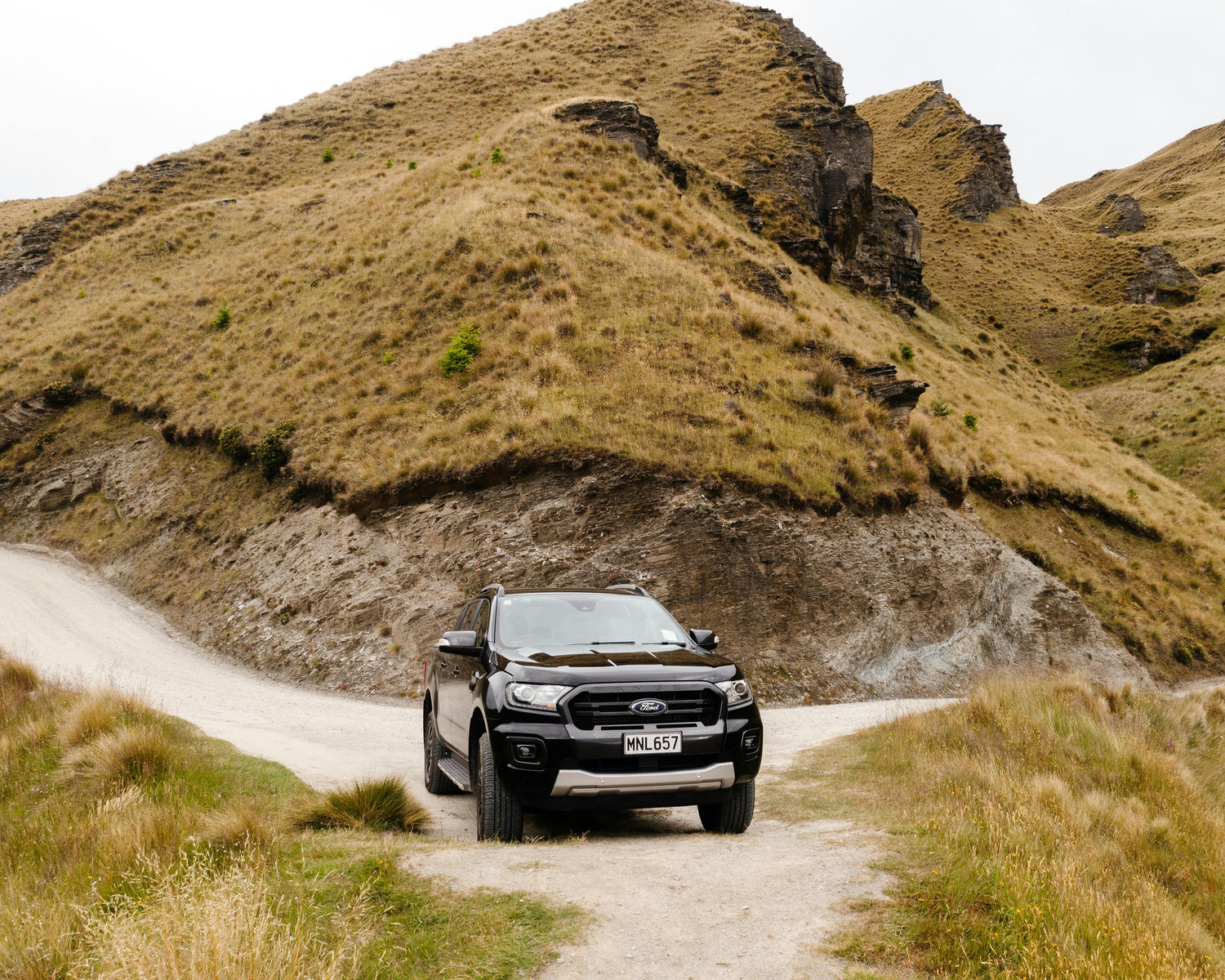 Ford ranger off-roading 4x4 vehicle riving on off-road track in nz hills
