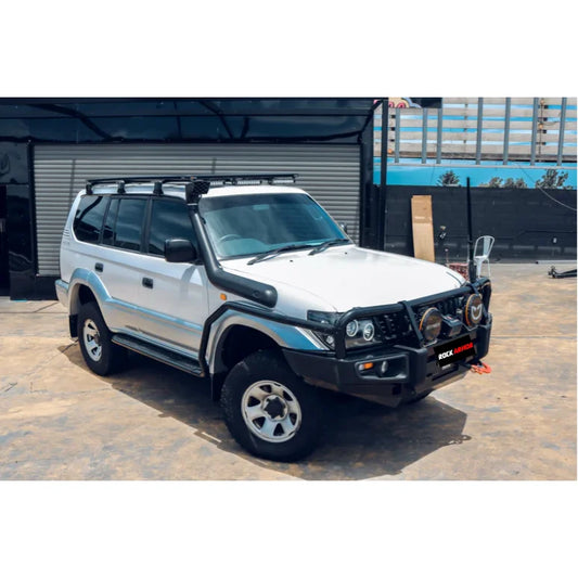 White off-road vehicle with roof rack and snorkel featuring Rockarmor Brushbar for Toyota Prado