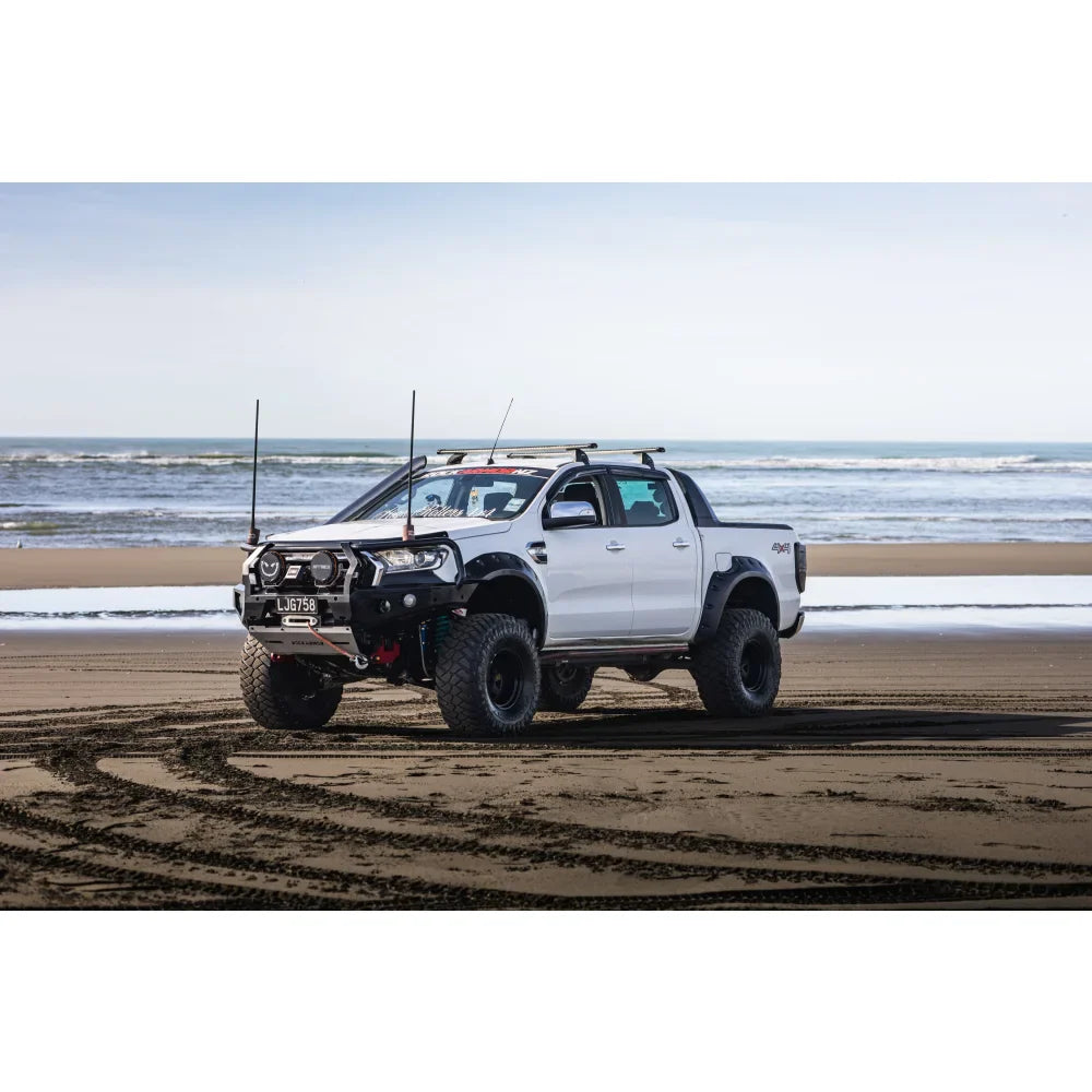 White modified pickup truck with hoop bullbar, driving lights, and synthetic winch rope