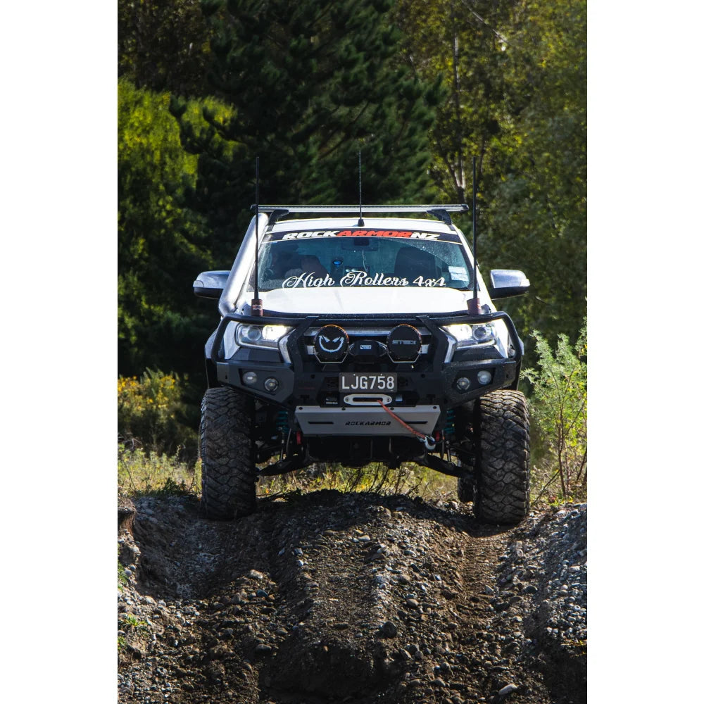 White off-road truck with hoop bullbar, driving lights, and synthetic winch rope installed
