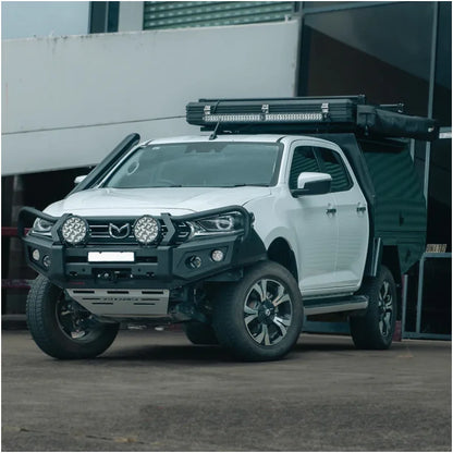 White Mazda pickup truck with off-road modifications featuring Rockarmor GT bull bar and driving lights