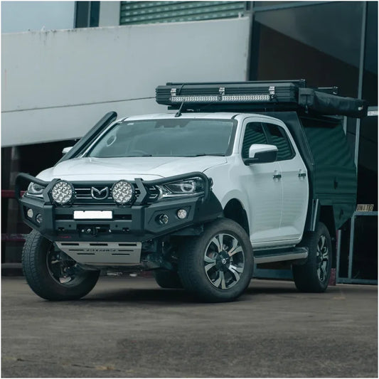 White Mazda pickup truck with off-road modifications featuring Rockarmor GT bull bar and driving lights