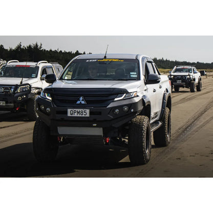 Modified white Mitsubishi pickup truck with Rockarmor GT bull bar and driving lights