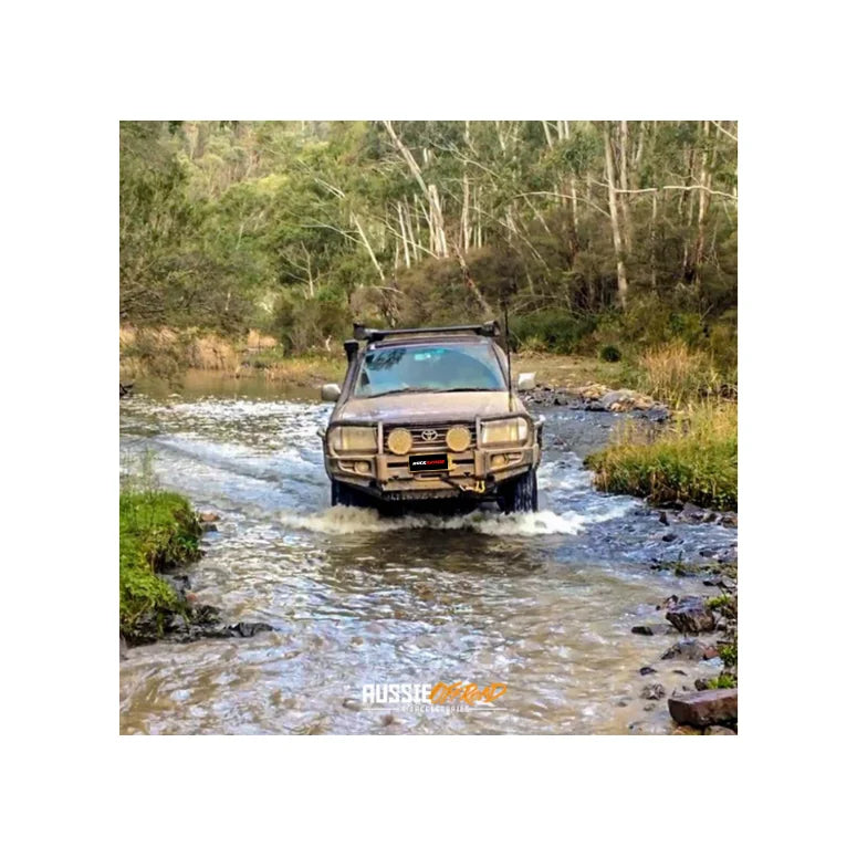 Brown off-road vehicle with Rockarmor premium steel bullbar and fog lights attachment