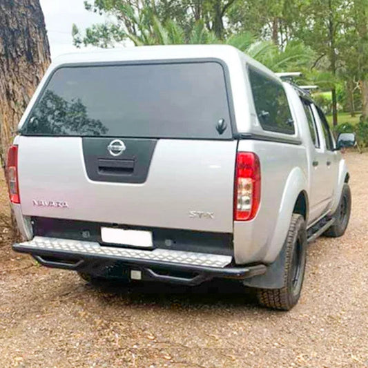 Silver Nissan Navara pickup truck with Rockarmor premium steel step tow bar and rear step