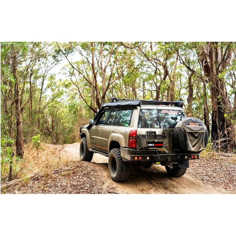 Tan off-road vehicle with Rockarmor Steel Dual Wheel Carrier for Nissan Patrol Y61