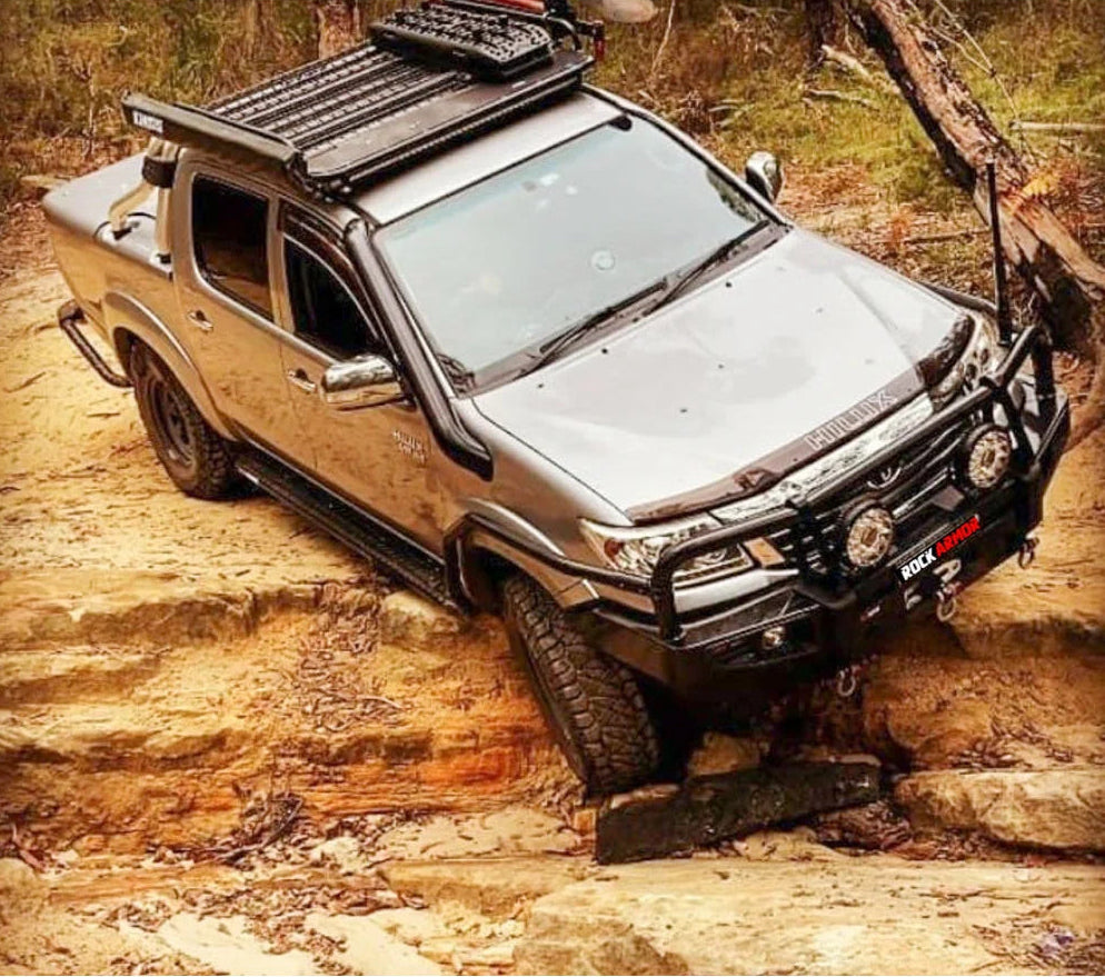 Silver off-road pickup truck featuring steel checker plate Rockslider side steps with fitting video