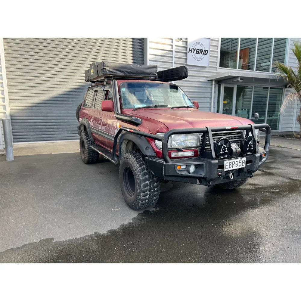 Maroon off-road vehicle with steel checker plate Rockarmor Steel Rockslider side steps for Toyota Landcruiser Fj80